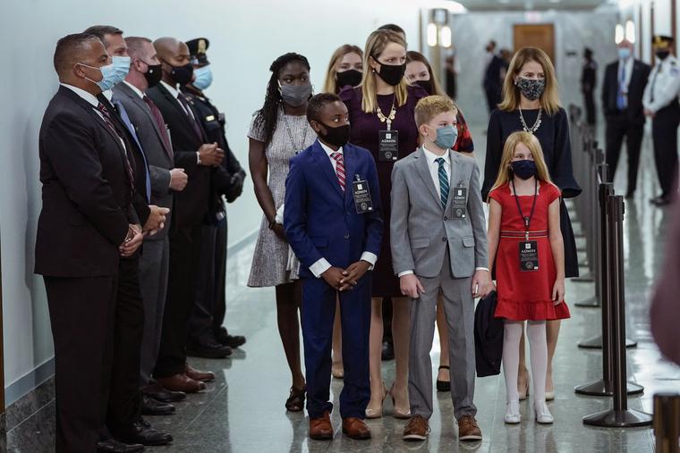 Accompanied by her seven children, Amy Coney Barrett arrives Oct. 12, 2020, for her Senate Judiciary Committee confirmation in Washington, DC. Accompanied by her seven children, Amy Coney Barrett arrives Oct. 12, 2020, for her Senate Judiciary Committee confirmation in Washington, DC.