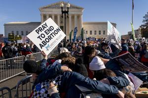 A group of pro-life protesters pray together in front of the U.S. Supreme Court on Dec. 1 in Washington, as the court hears arguments in a case from Mississippi, where a 2018 law would ban abortions after 15 weeks of pregnancy. A group of pro-life protesters pray together in front of the U.S. Supreme Court on Dec. 1 in Washington, as the court hears arguments in a case from Mississippi, where a 2018 law would ban abortions after 15 weeks of pregnancy.
