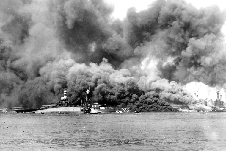 The USS Oklahoma capsizes in a photo taken during the attack on Pearl Harbor on Dec. 7, 1941. Father Aloysius Schmitt, who had just celebrated 7am Mass on board, died after saving sailors’ lives. The USS Oklahoma capsizes in a photo taken during the attack on Pearl Harbor on Dec. 7, 1941. Father Aloysius Schmitt, who had just celebrated 7am Mass on board, died after saving sailors’ lives.
