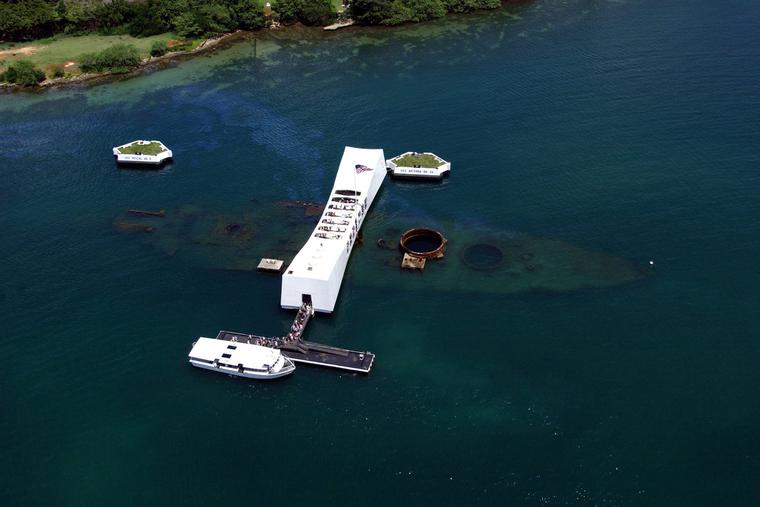 An aerial view of the USS Arizona Memorial with a U.S. Navy (USN) Tour Boat, USS Arizona Memorial Detachment, is shown moored at the pier as visitors disembark to visit and pay their respects to the sailors and Marines who lost their lives during the attack on Pearl Harbor on Dec. 7, 1941. An aerial view of the USS Arizona Memorial with a U.S. Navy (USN) Tour Boat, USS Arizona Memorial Detachment, is shown moored at the pier as visitors disembark to visit and pay their respects to the sailors and Marines who lost their lives during the attack on Pearl Harbor on Dec. 7, 1941.