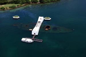 An aerial view of the USS Arizona Memorial with a U.S. Navy (USN) Tour Boat, USS Arizona Memorial Detachment, is shown moored at the pier as visitors disembark to visit and pay their respects to the sailors and Marines who lost their lives during the attack on Pearl Harbor on Dec. 7, 1941. An aerial view of the USS Arizona Memorial with a U.S. Navy (USN) Tour Boat, USS Arizona Memorial Detachment, is shown moored at the pier as visitors disembark to visit and pay their respects to the sailors and Marines who lost their lives during the attack on Pearl Harbor on Dec. 7, 1941.