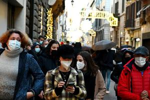 Christmas shoppers walk along the Via Condotti luxury shopping street in central Rome on Dec. 5. Christmas shoppers walk along the Via Condotti luxury shopping street in central Rome on Dec. 5.