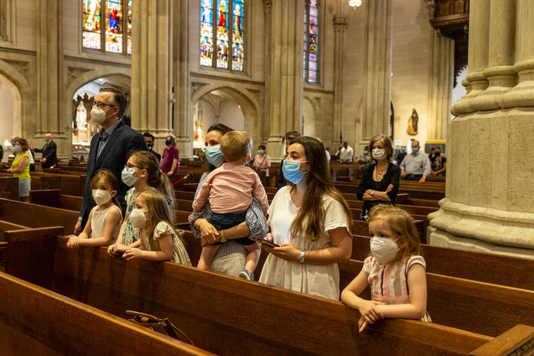 A family prays during St. Patrick's Cathedral Sunday first public Mass since March 2020 when pandemic stopped large gatherings A family prays during St. Patrick's Cathedral Sunday first public Mass since March 2020 when pandemic stopped large gatherings