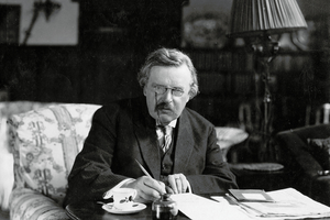 G.K. Chesterton at his desk. G.K. Chesterton at his desk.