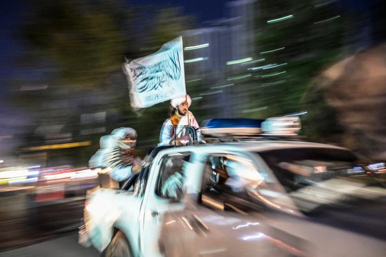 Members of the Taliban patrol in the back of a pickup truck with a Taliban flag along a street in Kabul on Sept. 30. Members of the Taliban patrol in the back of a pickup truck with a Taliban flag along a street in Kabul on Sept. 30.