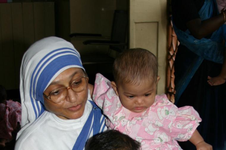 Missionary of Charity sister cares for unwanted children at Nirmala Shishu Bhavan orphanage in Kolkata, India. Missionary of Charity sister cares for unwanted children at Nirmala Shishu Bhavan orphanage in Kolkata, India.