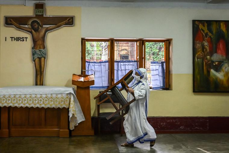 A sister carries a chair inside a hall after taking part in special prayers to mark the death anniversary of Mother Teresa at the Missionaries of Charity Mother House in Kolkata on Sept. 5, 2021. A sister carries a chair inside a hall after taking part in special prayers to mark the death anniversary of Mother Teresa at the Missionaries of Charity Mother House in Kolkata on Sept. 5, 2021.