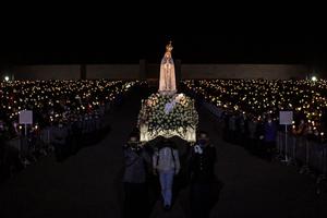 The statue of Our Lady of Fatima is carried during the candlelight procession in the annual Fatima pilgrimage at the Fatima shrine in central Portugal. The statue of Our Lady of Fatima is carried during the candlelight procession in the annual Fatima pilgrimage at the Fatima shrine in central Portugal.