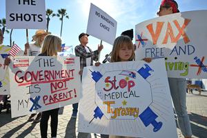 People demonstrate against COVID-19 vaccine mandates for students in Huntington Beach, California, on Jan. 3. People demonstrate against COVID-19 vaccine mandates for students in Huntington Beach, California, on Jan. 3.