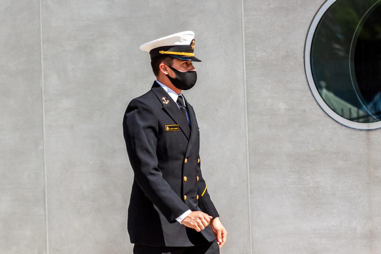 A cadet attending the US Naval Academy (USNA) is wearing a face mask due to COVID 19 pandemic. A cadet attending the US Naval Academy (USNA) is wearing a face mask due to COVID 19 pandemic.