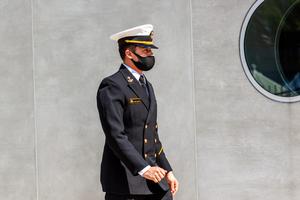 A cadet attending the US Naval Academy (USNA) is wearing a face mask due to COVID 19 pandemic. A cadet attending the US Naval Academy (USNA) is wearing a face mask due to COVID 19 pandemic.