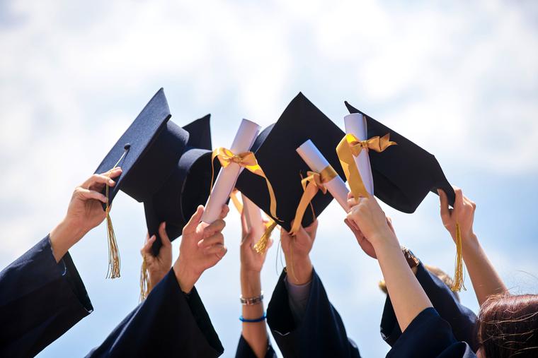 Grads throw their hats into the air after commencement ceremony. Grads throw their hats into the air after commencement ceremony.