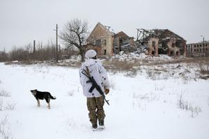 A serviceman of Ukrainian Military Forces walks close to the front-line with Russia-backed separatists, in the village of Peski, in the self-proclaimed Donetsk People's Republic (DPR) in eastern Ukraine on January 25, 2022. A serviceman of Ukrainian Military Forces walks close to the front-line with Russia-backed separatists, in the village of Peski, in the self-proclaimed Donetsk People's Republic (DPR) in eastern Ukraine on January 25, 2022.