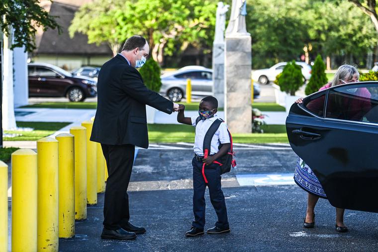 The new Superintendent of Schools for the Archdiocese of Miami, Jim Rigg, greets a student on his first day of school after summer vacation at St. Lawrence Catholic School in Miami, Aug. 18, 2021. The new Superintendent of Schools for the Archdiocese of Miami, Jim Rigg, greets a student on his first day of school after summer vacation at St. Lawrence Catholic School in Miami, Aug. 18, 2021.