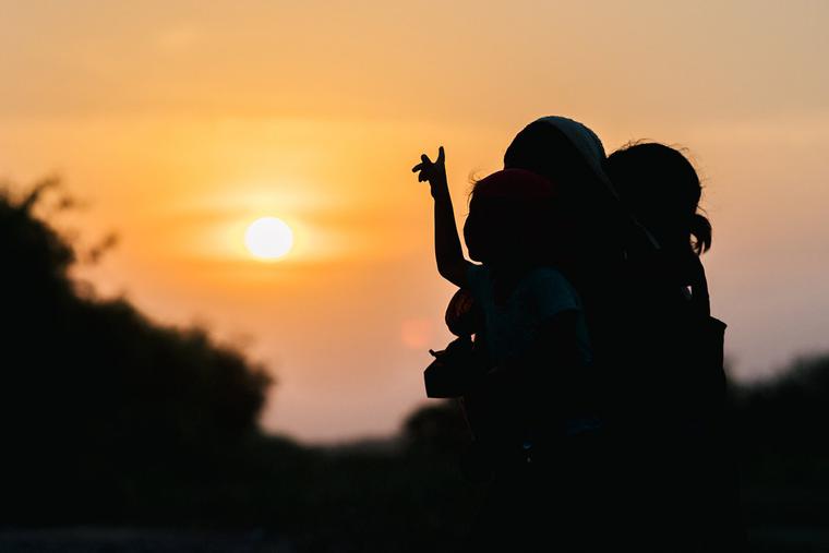 A migrant family watches the sunset June 21, 2021, in La Joya, Texas. A migrant family watches the sunset June 21, 2021, in La Joya, Texas.