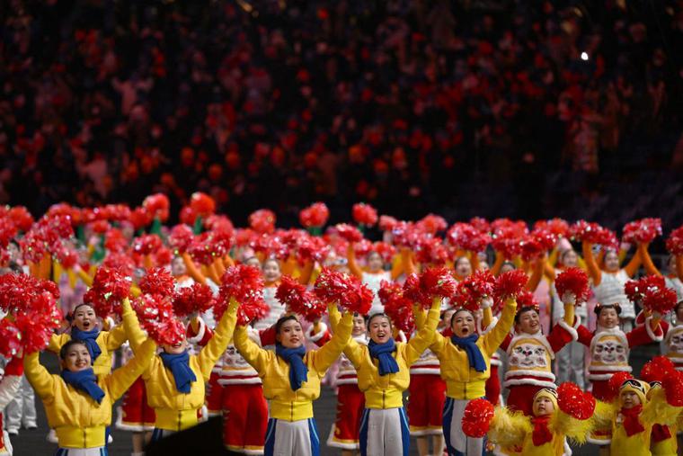 Performers wave upon the arrival of China's President Xi Jinping (not pictured) before the start of the opening ceremony of the Beijing 2022 Winter Olympic Games, at the National Stadium, known as the Bird's Nest, in Beijing, on February 4, 2022. Performers wave upon the arrival of China's President Xi Jinping (not pictured) before the start of the opening ceremony of the Beijing 2022 Winter Olympic Games, at the National Stadium, known as the Bird's Nest, in Beijing, on February 4, 2022.