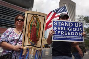 Protesters hold signs at a rally for Religious Freedom on June 8, 2012, in Miami. Protesters hold signs at a rally for Religious Freedom on June 8, 2012, in Miami.