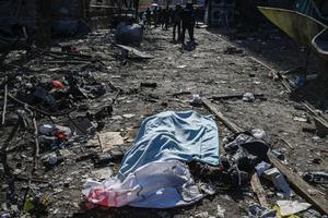 A body covered with a blanket lies among damages in a residential area after shelling in Kyiv on March 18, 2022, as Russian troops try to encircle the Ukrainian capital as part of their slow-moving offensive. -Authorities in Kyiv said one person was killed early today when a downed Russian rocket struck a residential building in the capital's northern suburbs. They said a school and playground were also hit. A body covered with a blanket lies among damages in a residential area after shelling in Kyiv on March 18, 2022, as Russian troops try to encircle the Ukrainian capital as part of their slow-moving offensive. -Authorities in Kyiv said one person was killed early today when a downed Russian rocket struck a residential building in the capital's northern suburbs. They said a school and playground were also hit.