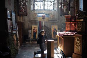 A woman prays at the cathedral after the funeral ceremony for Ukrainian officer Ivan Skrypnyk on March 17 in Lviv, Ukraine. The soldier died in a March 13 Russian airstrike on the nearby International Center for Peacekeeping and Security at the Yavoriv military complex. A woman prays at the cathedral after the funeral ceremony for Ukrainian officer Ivan Skrypnyk on March 17 in Lviv, Ukraine. The soldier died in a March 13 Russian airstrike on the nearby International Center for Peacekeeping and Security at the Yavoriv military complex.