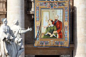 A tapestry featuring the portrait of Sts. Louis and Zélie Martin, the parents of St. Thérèse of Lisieux and the first married couple to be canonized together, is draped from the balcony overlooking St. Peter's Square on Oct. 18, 2015. A tapestry featuring the portrait of Sts. Louis and Zélie Martin, the parents of St. Thérèse of Lisieux and the first married couple to be canonized together, is draped from the balcony overlooking St. Peter's Square on Oct. 18, 2015.