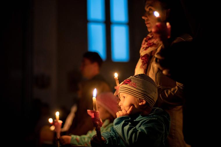 People light candles as they celebrate the Holy Saturday Easter vigil in the Catholic Church of St. Mary of Snows in Bratislava, Slovakia, on Easter Eve, April 20, 2019. People light candles as they celebrate the Holy Saturday Easter vigil in the Catholic Church of St. Mary of Snows in Bratislava, Slovakia, on Easter Eve, April 20, 2019.