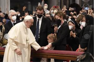 Pope Francis greets a child at the Divine Mercy Sunday Mass at St. Peter's Basilica on April 24.