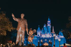 A statue of Walt Disney and Mickey Mouse is seen in the foreground at Disneyland in Anaheim, California. A statue of Walt Disney and Mickey Mouse is seen in the foreground at Disneyland in Anaheim, California.