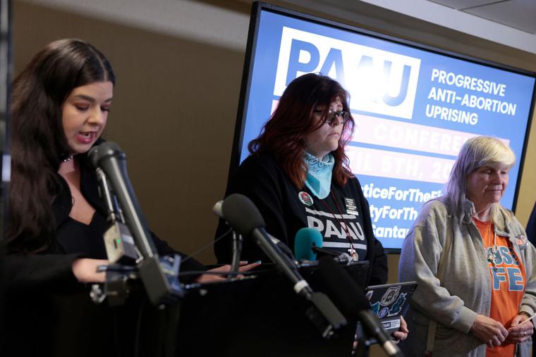 Pro-life activists Lauren Handy (c) and Joan Andrews Bell (r) listen as Terrisa Bukovinac speaks during a news conference April 5 at the Hyatt Regency in Washington, D.C. The activists are members of the Progressive Anti-Abortion Uprising (PAAU) group. Pro-life activists Lauren Handy (c) and Joan Andrews Bell (r) listen as Terrisa Bukovinac speaks during a news conference April 5 at the Hyatt Regency in Washington, D.C. The activists are members of the Progressive Anti-Abortion Uprising (PAAU) group.
