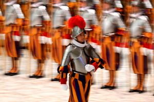A new Swiss Guard returns to his place after his swearing-in during a ceremony for new recruits of the Pontifical Swiss Guard on Friday in the Paul VI Audience Hall at the Vatican. A new Swiss Guard returns to his place after his swearing-in during a ceremony for new recruits of the Pontifical Swiss Guard on Friday in the Paul VI Audience Hall at the Vatican.