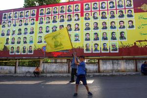 A boy waves a flag Lebanon's Iran-backed Shiite group Hezbollah during a rally to attend a speech by Hezbollah leader Hassan Nasrallah, broadcast on a giant screen, in the southern city of Nabatiyeh, on May 9, 2022, ahead of the upcoming parliamentary elections on May 15. The portraits on billboards are fighters from the group who were killed in confrontations with Israel or in Syria. A boy waves a flag Lebanon's Iran-backed Shiite group Hezbollah during a rally to attend a speech by Hezbollah leader Hassan Nasrallah, broadcast on a giant screen, in the southern city of Nabatiyeh, on May 9, 2022, ahead of the upcoming parliamentary elections on May 15. The portraits on billboards are fighters from the group who were killed in confrontations with Israel or in Syria.