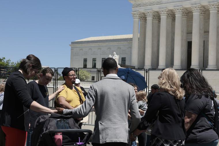 Pro-lifers pray in front of the U.S. Supreme Court Building on May 10 in Washington. Pro-lifers pray in front of the U.S. Supreme Court Building on May 10 in Washington.