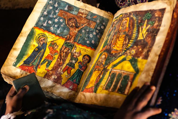 A child reads a hand-painted Bible in Adigrat. A child reads a hand-painted Bible in Adigrat.