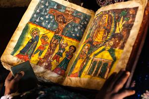 A child reads a hand-painted Bible in Adigrat. A child reads a hand-painted Bible in Adigrat.