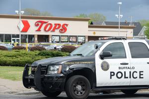 Police are shown on scene at a Tops Friendly Market on May 14 in Buffalo, New York, after 10 people were killed and three injured after a mass shooting at the store; the shooter is in police custody. Police are shown on scene at a Tops Friendly Market on May 14 in Buffalo, New York, after 10 people were killed and three injured after a mass shooting at the store; the shooter is in police custody.