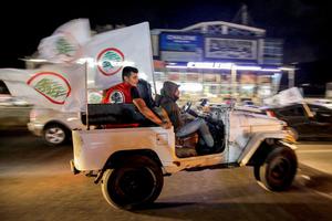 Supporters of the Lebanese Forces celebrate in Lebanon's northern coastal city of Batroun as they await results after the end of voting in the parliamentary elections on May 15. Supporters of the Lebanese Forces celebrate in Lebanon's northern coastal city of Batroun as they await results after the end of voting in the parliamentary elections on May 15.