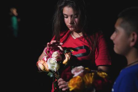 A young girl holds flowers outside the Willie de Leon Civic Center where people gather to mourn in Uvalde, Texas, May 24, 2022. A young girl holds flowers outside the Willie de Leon Civic Center where people gather to mourn in Uvalde, Texas, May 24, 2022.