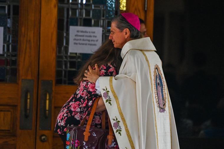 San Antonio Archbishop Gustavo Garcia-Siller receives a woman as she arrives for the funeral Mass of Irma Linda Garcia and Jose Antonio Garcia at Sacred Heart Catholic Church in Uvalde, Texas, on June 1. San Antonio Archbishop Gustavo Garcia-Siller receives a woman as she arrives for the funeral Mass of Irma Linda Garcia and Jose Antonio Garcia at Sacred Heart Catholic Church in Uvalde, Texas, on June 1.