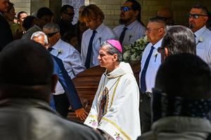 San Antonio Archbishop Gustavo Garcia-Siller accompanies pallbearers carrying the casket of Irma Linda Garcia and José Antonio Garcia during their funeral Mass at Sacred Heart Catholic Church in Uvalde, Texas, on June 1. Irma, a teacher, was killed in the elementary school shooting, and her husband died two days later of a heart attack. San Antonio Archbishop Gustavo Garcia-Siller accompanies pallbearers carrying the casket of Irma Linda Garcia and José Antonio Garcia during their funeral Mass at Sacred Heart Catholic Church in Uvalde, Texas, on June 1. Irma, a teacher, was killed in the elementary school shooting, and her husband died two days later of a heart attack.