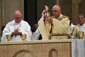 Archbishop Joseph Naumann of Kansas City, Kansas, elevates the Eucharist at the Mass for Life at the Basilica of the National Shrine of the Immaculate Conception on Jan. 23, 2020. Cardinal Timothy Dolan of New York is at left. Archbishop Joseph Naumann of Kansas City, Kansas, elevates the Eucharist at the Mass for Life at the Basilica of the National Shrine of the Immaculate Conception on Jan. 23, 2020. Cardinal Timothy Dolan of New York is at left.