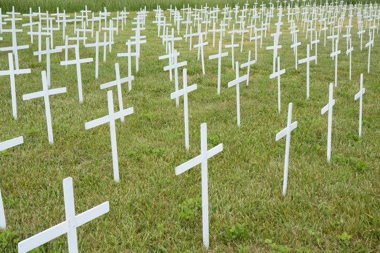 Many anonymous white crosses mark the graves of unborn children. Many anonymous white crosses mark the graves of unborn children.