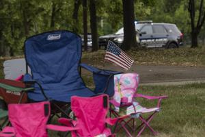 A U.S. flag is seen attached to abandoned lawn chairs along the streets at the scene of the Fourth of July parade mass shooting in Highland Park, Illinois. A shooter opened fire Monday, killing at least six people, officials said. A U.S. flag is seen attached to abandoned lawn chairs along the streets at the scene of the Fourth of July parade mass shooting in Highland Park, Illinois. A shooter opened fire Monday, killing at least six people, officials said.