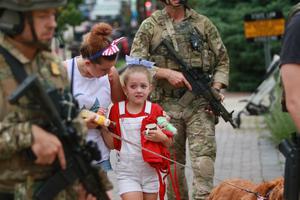 Law enforcement escorts a family away from the scene of a mass shooting at a Fourth of July parade in Highland Park, Illinois. Law enforcement escorts a family away from the scene of a mass shooting at a Fourth of July parade in Highland Park, Illinois.