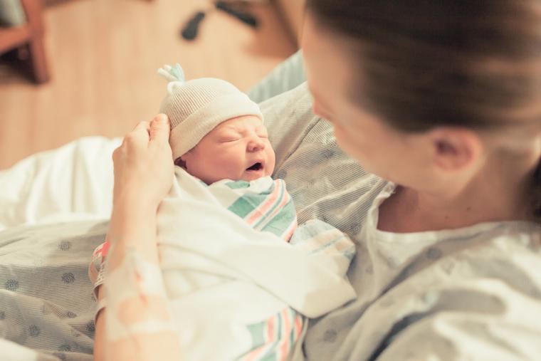 A ne wmother holds her baby after giving birth. A ne wmother holds her baby after giving birth.