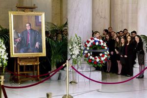 Law clerks and Supreme Court staff watch a private ceremony in the Great Hall of the Supreme Court where Justice Antonin Scalia lies in repose on Feb. 19, 2016, in Washington, DC. Law clerks and Supreme Court staff watch a private ceremony in the Great Hall of the Supreme Court where Justice Antonin Scalia lies in repose on Feb. 19, 2016, in Washington, DC.