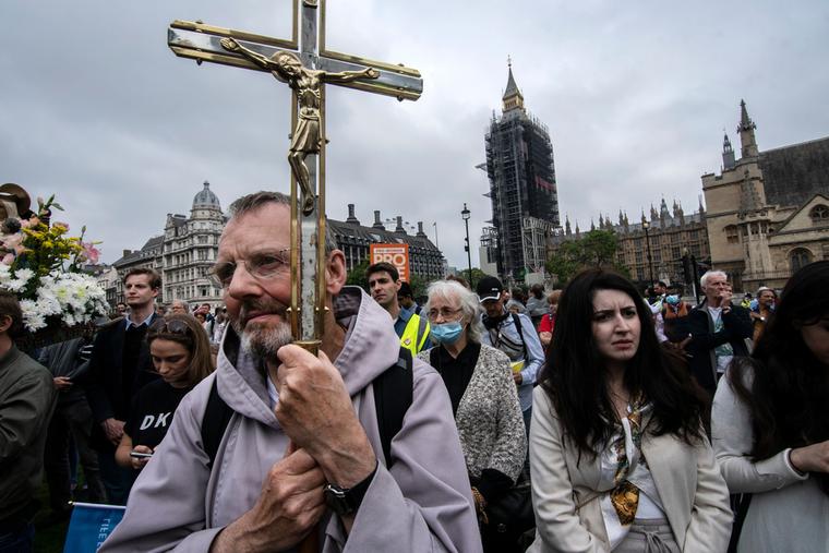 A man holds a crucifix during the March for Life in London. A man holds a crucifix during the March for Life in London.