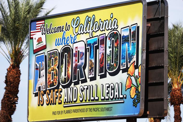 A billboard reads, ‘Welcome to California where abortion is safe and still legal’ on July 12 in Rancho Mirage, California. The billboard was paid for by Planned Parenthood of the Pacific Southwest. The number of travelers from outside states seeking abortions increased 900% at Planned Parenthood clinics in San Bernardino and Orange counties the week following the Supreme Court’s decision in the Dobbs v. Jackson Women’s Health case. A billboard reads, ‘Welcome to California where abortion is safe and still legal’ on July 12 in Rancho Mirage, California. The billboard was paid for by Planned Parenthood of the Pacific Southwest. The number of travelers from outside states seeking abortions increased 900% at Planned Parenthood clinics in San Bernardino and Orange counties the week following the Supreme Court’s decision in the Dobbs v. Jackson Women’s Health case.