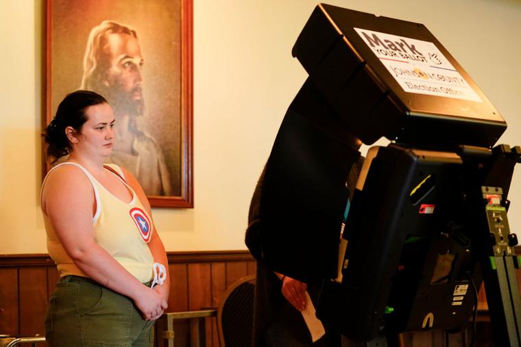 A poll worker helps a voter cast their ballot in the Kansas Primary Election at Merriam Christian Church on August 02, 2022 in Merriam, Kansas. A poll worker helps a voter cast their ballot in the Kansas Primary Election at Merriam Christian Church on August 02, 2022 in Merriam, Kansas.