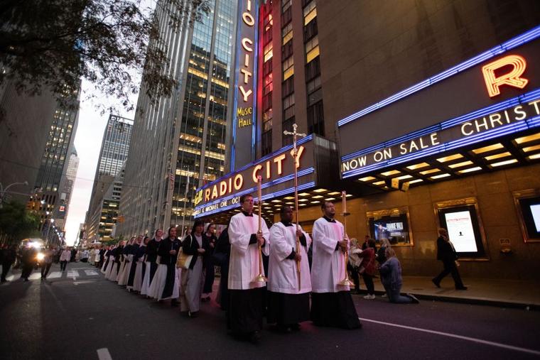 The cross, preceding the Blessed Sacrament, passes by during a Eucharistic procession on the streets of New York City on Oct. 10, 2023.