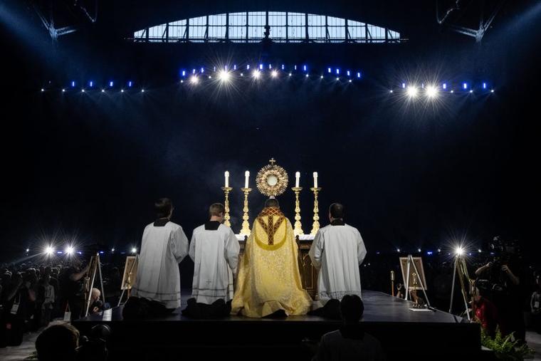 Bishop Andrew Cozzens of Crookston, Minnesota, who spearheaded the U.S. bishops’ initiative of Eucharistic Revival, adores Christ in the Eucharist with tens of thousands of people in Lucas Oil Stadium on July 17, 2024.